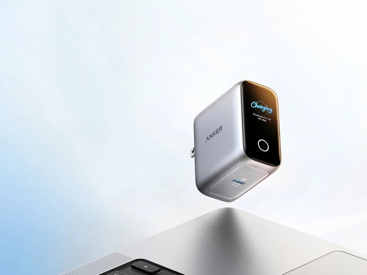 Strieborná nabíjačka Anker Laptop Charger Pro s farebným displejom nad notebookom